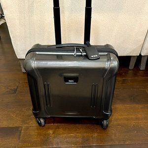 TUMI 4 wheeled spinner briefcase with retractable handle.